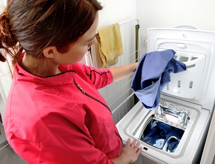 Loading laundry in a vertical washer