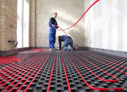 Laying pipes for underfloor heating by professionals