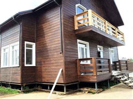 La façade de la maison est gainée de bois d'imitation.