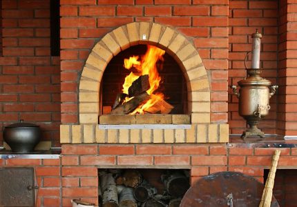 The crucible of a Russian stove with burning logs