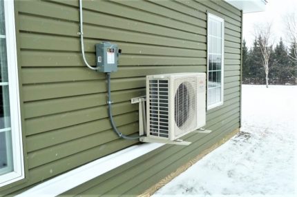 The outdoor unit of the split system in winter